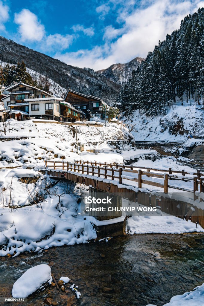 Hot spring resort in snow Footbridge Stock Photo