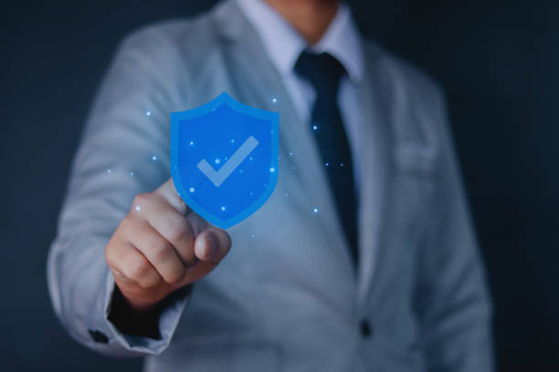 istock Businessman holding low polygonal shield with tick icon secure access system Business finance guarantees for investments 1480595341