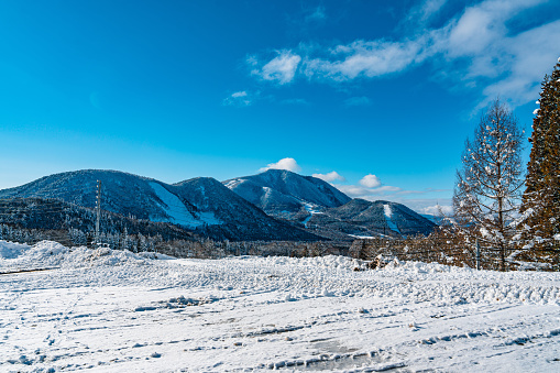 White snow and beautiful landscape during winter season in Japan against blue sky background