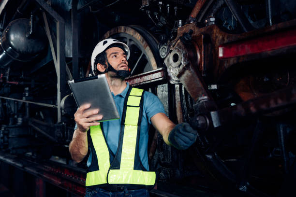 istock Male engineer maintenance locomotive engine wearing safety uniform. 1480596380
