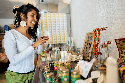 Mid adult woman trying on a ring at bazaar