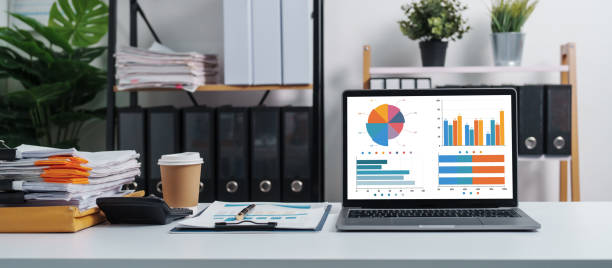 istock Stylish workspace with laptop, notebook, blank screen laptop on white table of bookkeeping. 1480598389