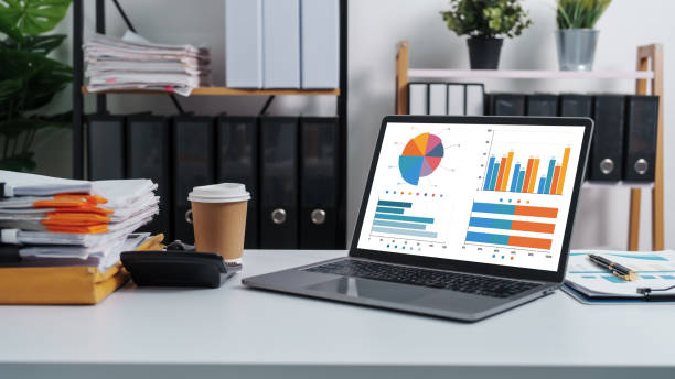 istock Stylish workspace with laptop, notebook, blank screen laptop on white table of bookkeeping. 1480598393