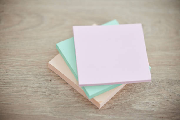 istock Top view, wood and sticky notes for brainstorming, ideas and planning with communication, schedule and paper. Mockup table and post it for messages, updates and motivation for goals, target and color 1480602444