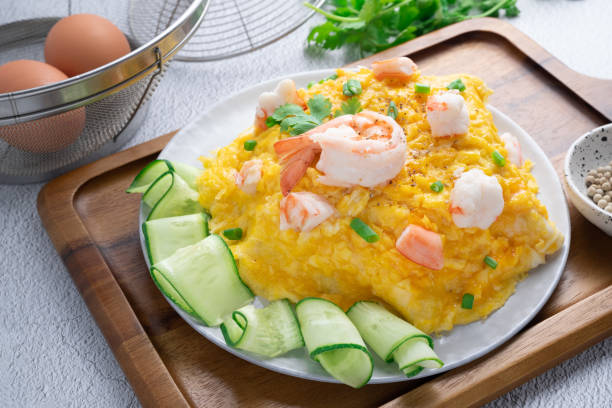 istock Omelet and shrimp on rice with cucumber in gray dish on concrete table. (Scrambled egg) 1480603240