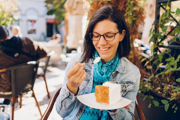 istock A young woman eating a cake 1480607514