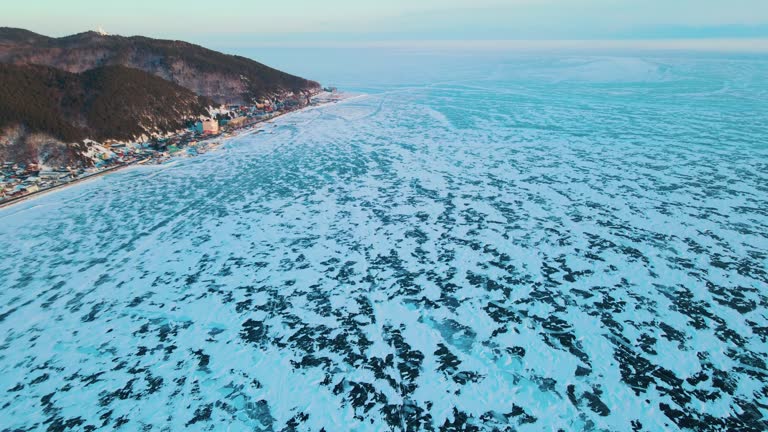 drone aerial view of cracks surface of the frozen lake of Baikal lake in winter season,Aerial view from the air. Winter. Ice Lake Baikal Russia