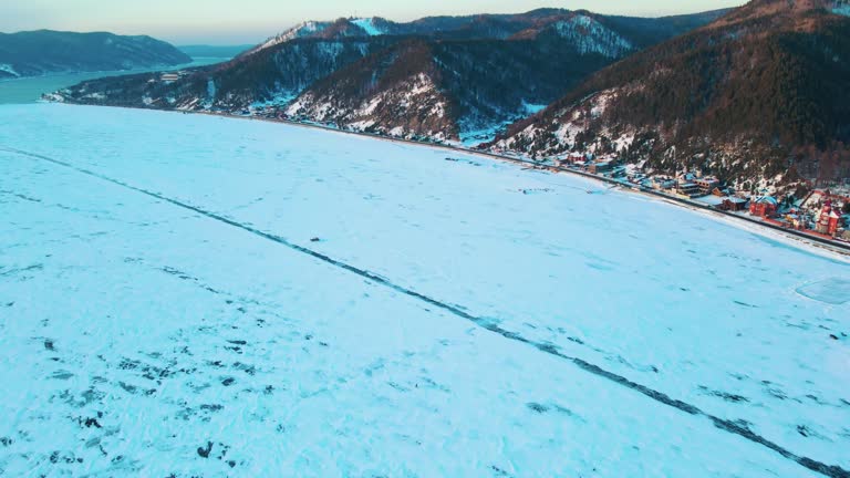 drone aerial view of cracks surface of the frozen lake of Baikal lake in winter season,Aerial view from the air. Winter. Ice Lake Baikal Russia