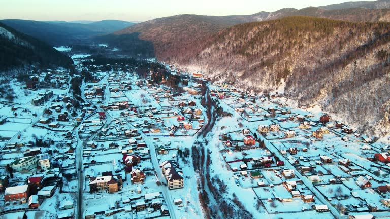 Beautiful drone areial view of Khuzhir village the largest village on Olkhon island, Russia. city town in winter snow city with frozen lake travel destination
