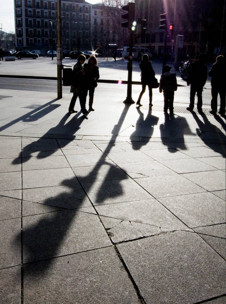 istock People waiting, shadows, traffic light in the foreground. 1480613188