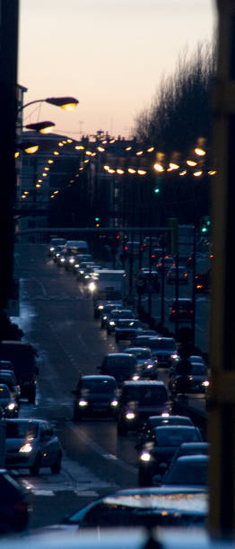 Street view in Vigo, row of  street lights, traffic jam. Street view in Vigo, row of  street lights and car head lights, traffic jam, straight avenue. Pontevedra province, Galicia, Spain. car city urban scene commuter stock pictures, royalty-free photos & images