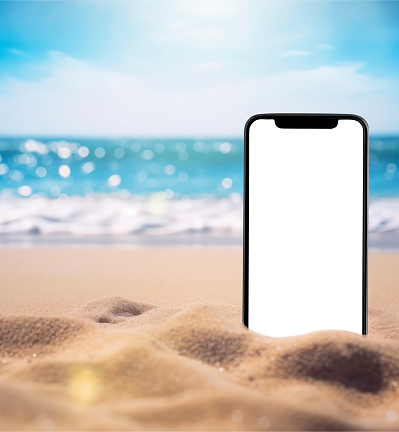 The smartphone lies buried in the sand on the beach, and takes a photo of the beach in the background.  can be used mock up for montage products display or design layout