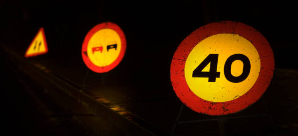 Temporary traffic signs in a row warning hazardous area, 40 km/h speed limit, overtaking forbidden, double direction. Galicia, Spain.