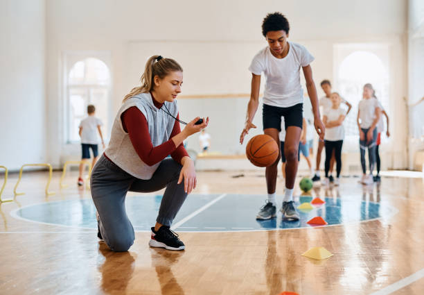 istock Young female coach using stopwatch during physical activity class with school kids. 1480620636