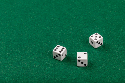 Poker's cubes in the air photographed on cloth