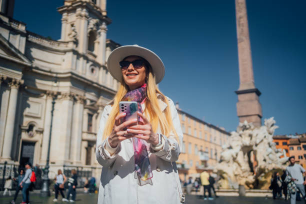 istock Young woman using phone on Piazza Navona Square, Rome 1480623572