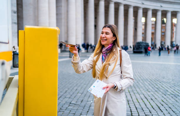 istock Woman puts a postcard in the Vatican mailbox 1480623679