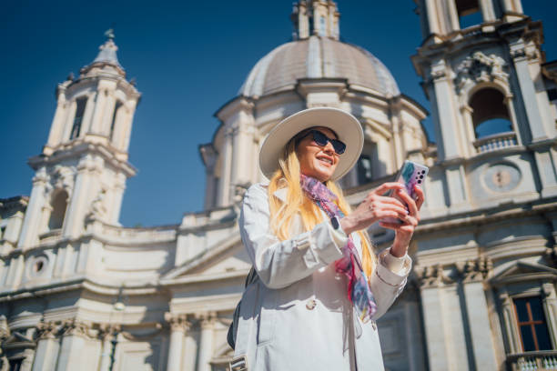 istock Young woman using phone on Piazza Navona Square, Rome 1480625079