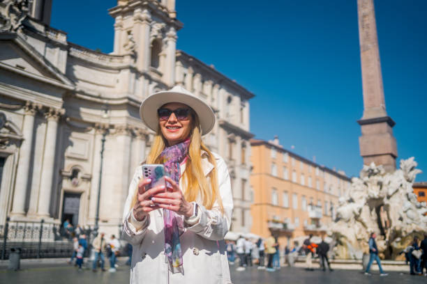 istock Young woman using phone on Piazza Navona Square, Rome 1480625219