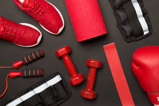 istock Red sport equipment on color background, top view 1480625492