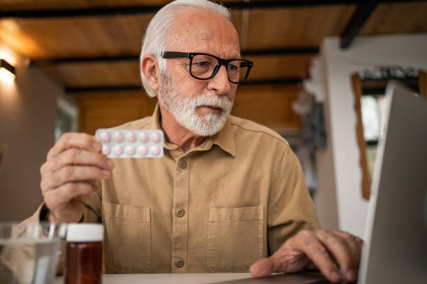 istock Photo of an elderly man at home taking regular medication. 1480626848