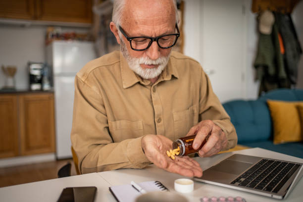 istock Senior man taking a pill 1480626900