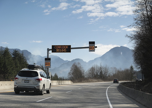 Hope, Canada - March 30, 2023: Traffic heads east along the scenic Crowsnest Highway or Highway 3 in the Fraser Valley Regional District. Spring morning with a light mist.