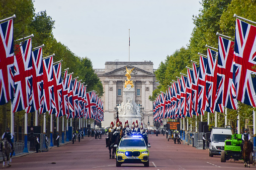 The Mall in London with golden autumn colours and British flags flying for the November birthday of the new King. UK