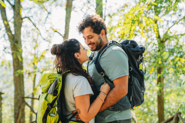 istock A couple is embracing together in the forest while they are taking a break from the hike 1480630722