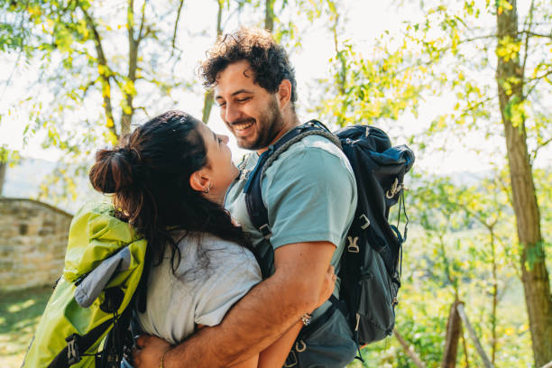 istock A couple is embracing together in the forest while they are taking a break from the hike 1480630810