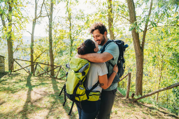 istock A couple is embracing together in the forest while they are taking a break from the hike 1480630811