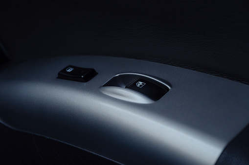 Car interior, close-up power window switch