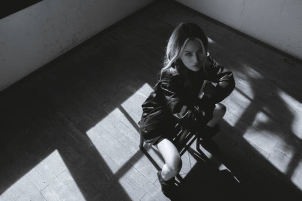 Beautiful fashionable blonde woman sitting in a chair.