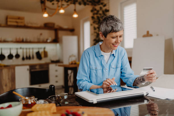istock Senior woman using  her credit card 1480641534