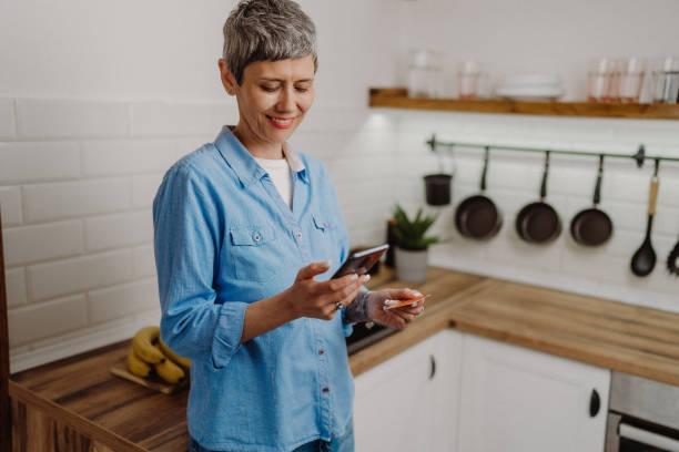 istock Senior woman using  her credit card 1480641767