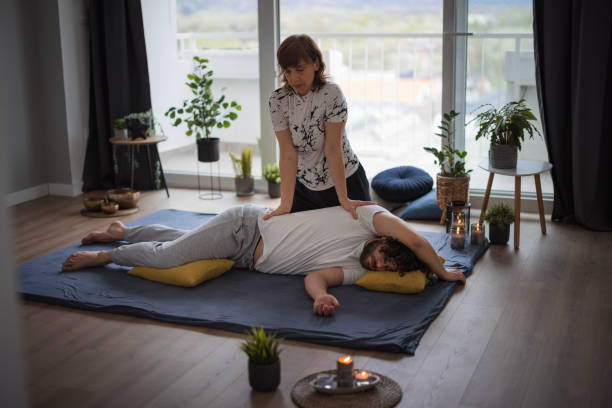 istock Therapist applying pressure on patient's torso during Shiatsu massage 1480641780