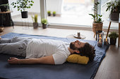 Man resting on a mat on the floor after a Shiatsu massage