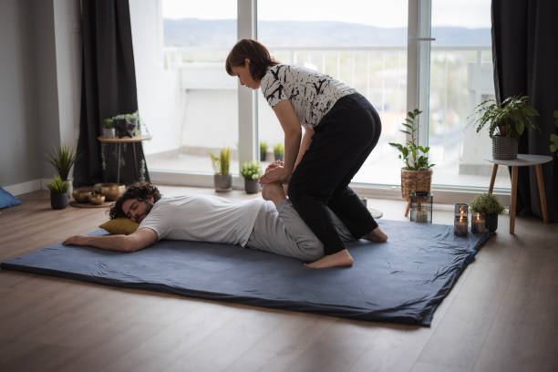 istock Physiotherapist doing leg massage to his patient 1480641897