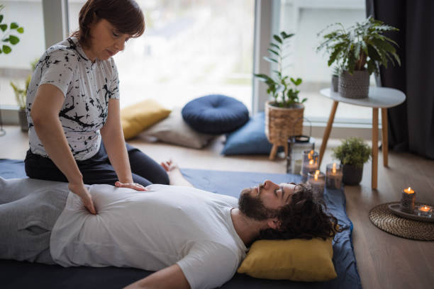 istock Masseuse performing a Shiatsu massage on stomach area 1480641913