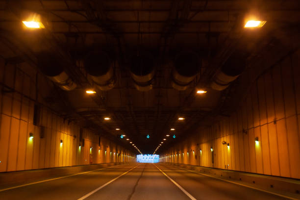 istock Empty long tunnel with yellow lamps on walls 1480644389