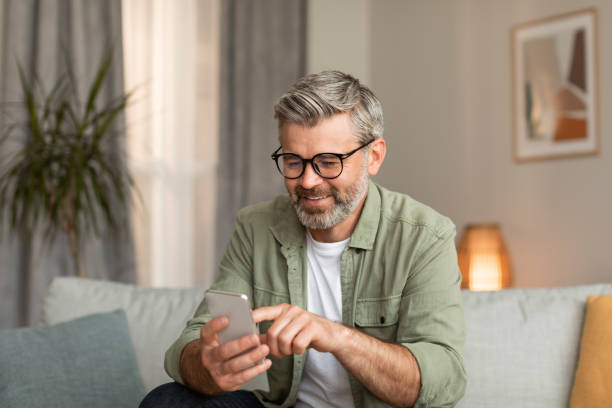 istock Glad elderly caucasian man in glasses typing on smartphone uses new app for communication 1480646329