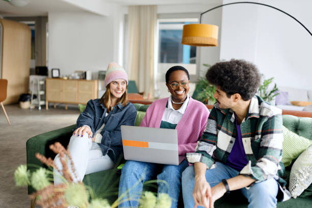a group of young multiracial people discussing at work - generatie z stockfoto's en -beelden