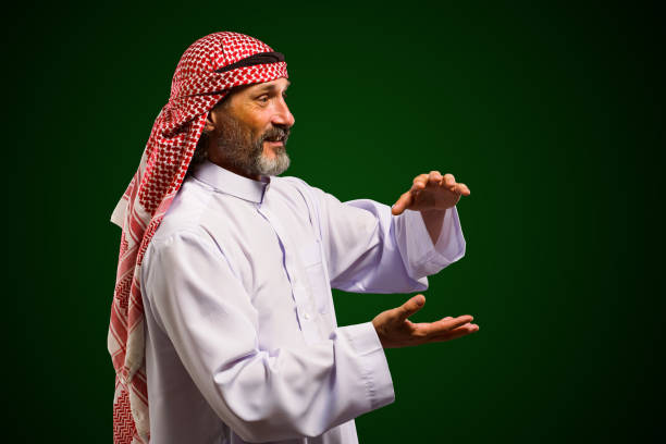 Arab sorcerer forming energy ball with his hands, performs mystical ritual. Mystical and supernatural aspects of traditional Arab spiritual practices.