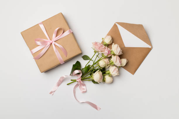 istock Envelope, gift box and rose flowers on white background, top view 1480649194
