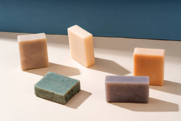 istock Pattern natural handmade soap of different sizes and colors. Brown background shadows of flowers from the sun. Cosmetic pedestal for product promotion 1480652099