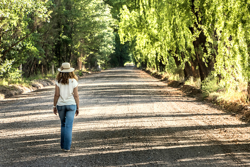 Woman walking in the Uspallata Valley. Las Heras, Mendoza, Argentina.