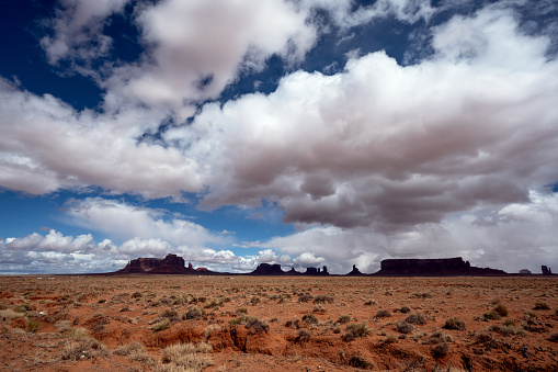 Monument Valley, a stunning natural wonder in Utah and Arizona, is renowned for its iconic Navajo mittens and awe-inspiring cloudscape