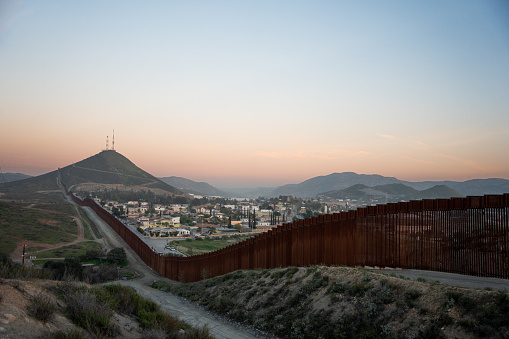 United States-Mexico border wall in Tecate, Mexico, stands as a symbol of national security and the effort to control the flow of people and goods between the two countries
