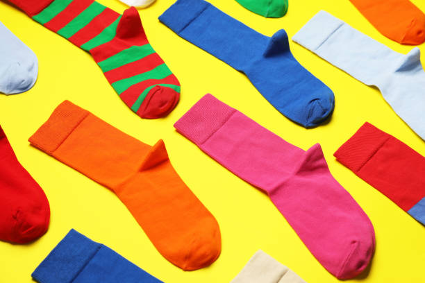 istock Composition of different colorful socks on yellow background 1480657658