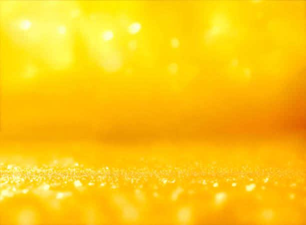 yellow abstract background with bokeh defocused lights stock photo